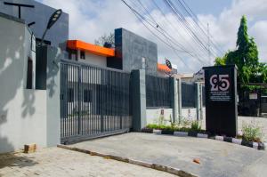 a building with a gate with a sign on it at NO 95 SUITES VI in Lagos