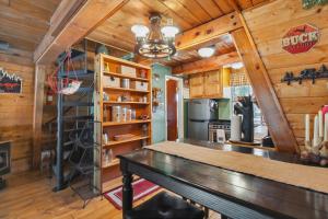 a kitchen with a table in a room with wooden walls at Near Trails Forest Lake Retreat with Backyard Oasis in Forest Lakes Estates