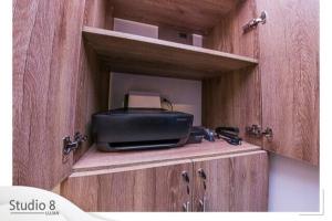 a wooden cabinet with a radio on top of it at Studio8 Lujan Apartament #7 in San José