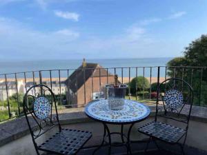 a table and two chairs on a balcony at The Turret- the best view in Folkestone in Folkestone