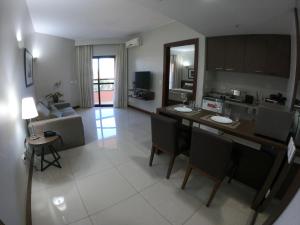 a kitchen and living room with a table and chairs at Bonaparte Excelente Apartamento #503 in Brasilia