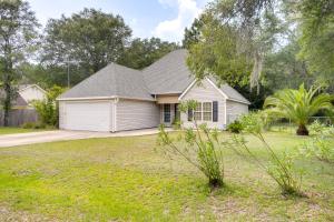 a small white house with a yard at Pet-Friendly Darien Vacation Rental with Patio! in Darien