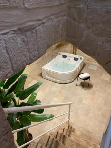 a bath tub sitting inside of a stone wall at 2 Love rooms in Corato