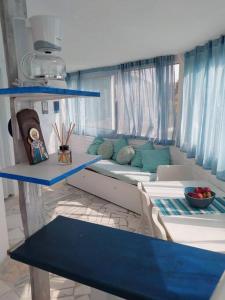 a living room with a couch and blue shelves at Stefanos' Art House in Halikounas