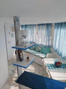 a living room with a couch and a window at Stefanos' Art House in Halikounas +24 photos