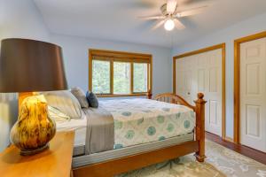 a bedroom with a bed and a table with a lamp at Bushkill Home with Access to Pools and Tennis Courts! in Bushkill +35 photos