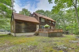 a large wooden house with a deck in the yard at Bushkill Home with Access to Pools and Tennis Courts! in Bushkill
