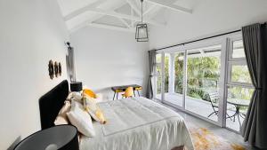 a bedroom with a bed and a large window at Stylish Loft Style Apartment in Durban