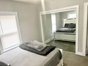 a bedroom with a bed and a large mirror at Cozy 2 Bedroom Home near Notre Dame in South Bend