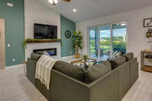 a living room with a couch and a fireplace at Port Saint Lucie Vacation Rental with Hot Tub! in Port Saint Lucie
