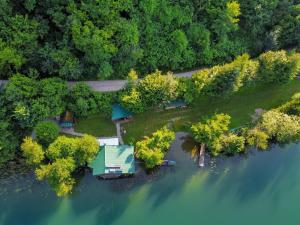 an aerial view of a house on an island in the water at ECO cabin Plivsko jezero Jajce in Jajce