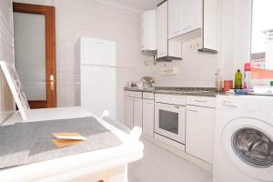 a white kitchen with a washing machine and a washer at 10A02 Precioso apartamento Pravia in Pravia