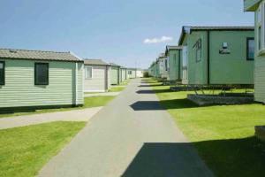 a row of mobile homes on a street at Rohannah static Caravan Fantastic Family and Friends Holiday in East Mersea