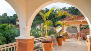 a balcony with potted plants on a house at The Terrace Villa in Kampala
