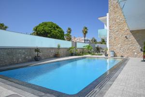 a large blue swimming pool next to a building at Villa Luz 37 - Jacuzzi Terrace & Swimming Pool in Albufeira