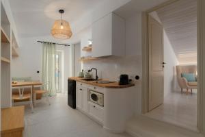 a kitchen with a sink and a dishwasher in it at ISTION ANDROS LUXURY SUITES in Andros