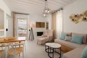a living room with a couch and a table at ISTION ANDROS LUXURY SUITES in Andros