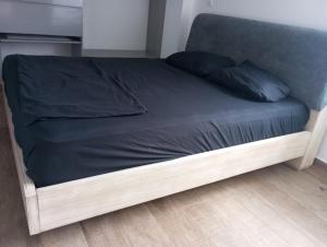 a bed with blue sheets and blue pillows on it at Beautiful & Central Penthouse in Quibdó in Quibdó