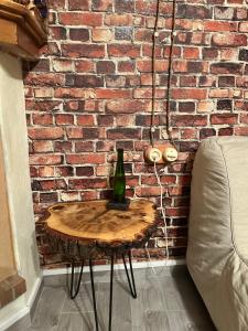 a table with a bottle on it next to a brick wall at Venezia in Abruzzo in Archi