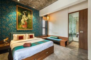 a bedroom with a bed and a painting on the wall at SaffronStays Amrapali - 5BHK Villa in Nashik with Pool, Lawn & Kids Play Area in Deolāli