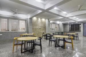 a row of tables and chairs in a room at Townhouse Ameerpet in Ameerpet