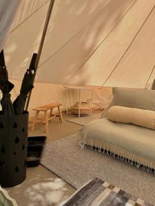 a tent with a bed and a table in it at Il Bosco di Paolo - Glamping in Sestola