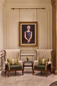 a room with two chairs and a painting on the wall at The Whitley, a Luxury Collection Hotel, Atlanta Buckhead in Atlanta