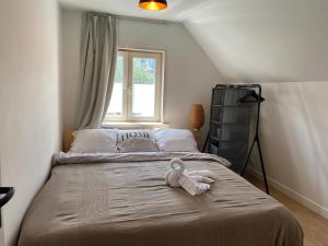 a bedroom with a bed with a stuffed animal on it at Beautiful house at beach, sea and dunes in Wijk aan Zee