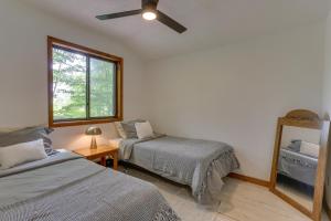 a bedroom with two beds and a mirror and a window at Screened Porch and Grill Lake Ariel Vacation Rental in Lake Ariel +31 photos