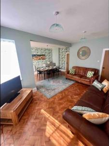 a living room with a couch and a table at Spacious Semi-detached Southsea House, Free Parking On Drive in Portsmouth