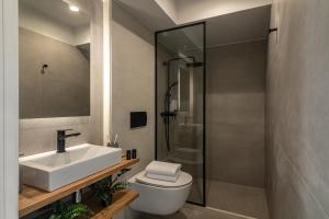 a bathroom with a sink and a toilet and a shower at Beachfront Salty Sea Luxury Suite 1 in Agios Nikolaos +23 photos