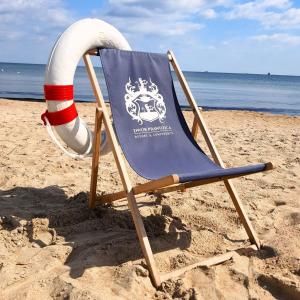 a beach chair with a life ball and a life preserver at Prawdzic Family Resort & Wellness in Gdańsk