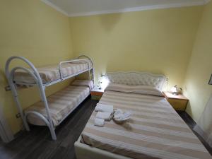 a bedroom with two bunk beds with towels on them at DONNA FILOMENA Residence in Marina di Camerota