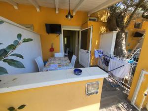 a room with a table and chairs in a house at DONNA FILOMENA Residence in Marina di Camerota