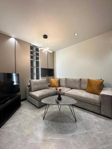 a living room with a couch and a coffee table at 30 Senses Luxury Apartment Insight in Ialyssos