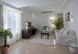 a living room with a couch and a table at Olives at Santa Monica in Marsa Matruh