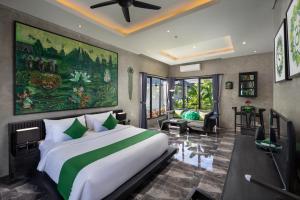 a bedroom with a large bed and a living room at Capung Asri Eco Luxury Resort with Private Pool Villas in Bedahulu