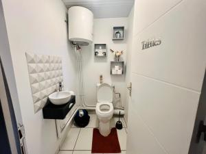 a small bathroom with a toilet and a sink at Charmante Villa, kaz’ AA.Liyah in Pointe-à-Pitre +17 photos