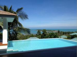 a swimming pool with a view of the ocean at Villa Sea Shore SDV184-By Samui Dream Villas in Choeng Mon Beach