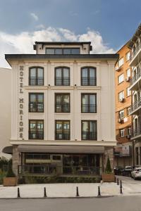 a large white building with windows on a street at Hotel Morione & Spa Center in Istanbul