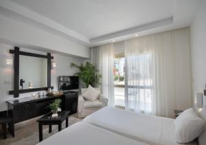a bedroom with a bed and a living room at Olives at Santa Monica in Marsa Matruh