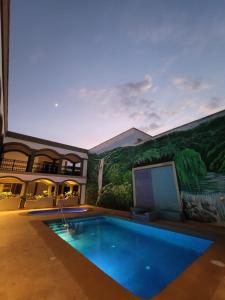 a house with a swimming pool and a mural at Real Cocula in Cocula