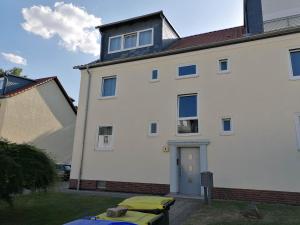 a large white building with a blue door at M-OASE Business Design I Küche I Parkplatz I Netflix in Braunschweig