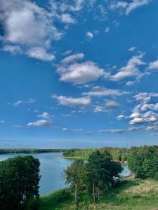 a view of a river under a cloudy sky at REMAR - Apartamenty z widokiem na Jezioro Biale in Augustów