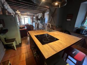 a kitchen with a wooden counter top with a stove at Cabane Du Cerf in Llivia