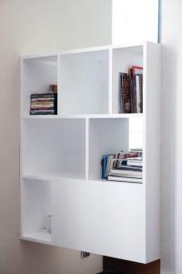 a white book shelf with books on it at Apartment Vila Olímpica Barcelona next to beach & garden in Barcelona