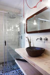 a bathroom with a sink and a glass shower at Apartment Vila Olímpica Barcelona next to beach & garden in Barcelona