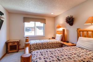 a bedroom with two beds and a window at Stunning Multi-Level Home near Hiking Trails and Main St, with PRIVATE Hot Tub WP33 in Breckenridge