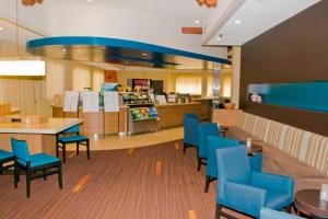 a restaurant with blue chairs and tables and a counter at Courtyard Santa Fe in Santa Fe