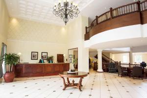 a lobby with a staircase and a table at Southern Sun Mbombela in Nelspruit